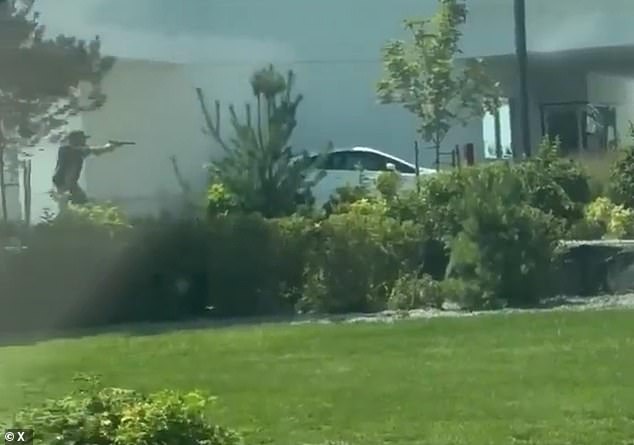 The armed civilian was caught on camera pointing his gun at Williams during the incident