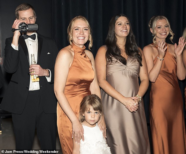 During peak wedding season, her business services 100 couples per week – and she has since expanded to Canada, Australia and the UK. Pictured are wedding guests using her camera