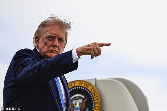 Donald Trump points a finger as he boards Air Force One at Morristown Municipal Airport in Morristown, New Jersey