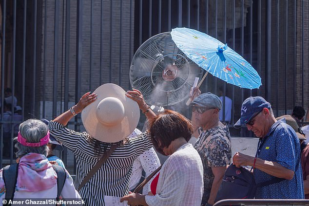 Tourists at the Rome Colosseum are sprayed with cooling mist on August 6, 2026