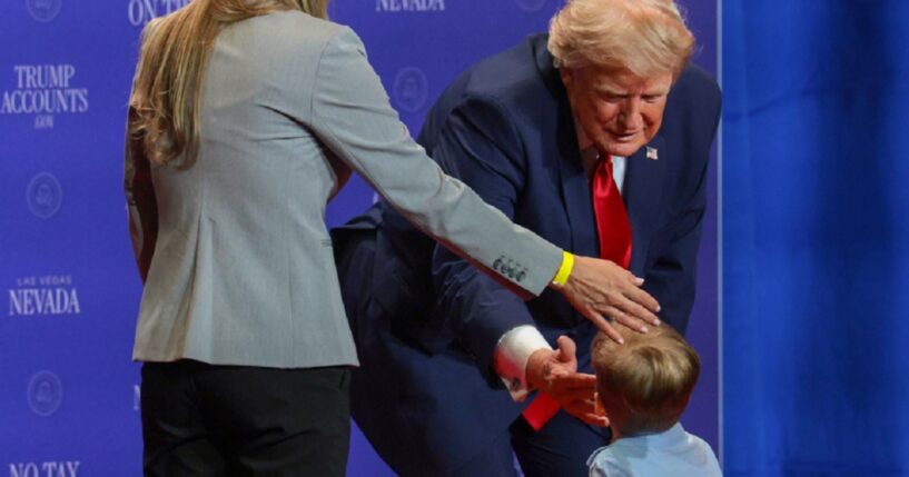 President Donald Trump greets a child onstage during an event at Red Rock Casino Resort and Spa on Wednesday in Las Vegas, moments before Trump turned on his grandfather switch.