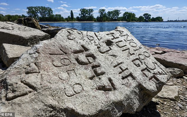 A so-called 'Hungerstein' (hunger stone), a hydrological landmark, from 1857, is visible in the Rhine River during low water levels in Worms, Germany, August 6 2026