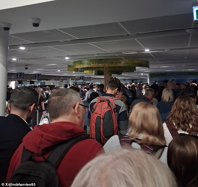 Hundreds of people were pictured waiting inside the airport terminal