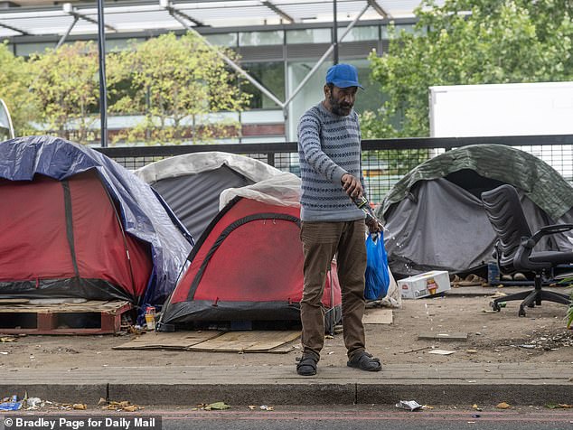 Litter piles up between the tents, which sit atop wooden pallets