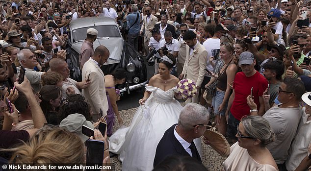 A crowd of more than 2,000 people gathered to watch the nuptials - which was for an entirely unconnected Portuguese couple from Madeira