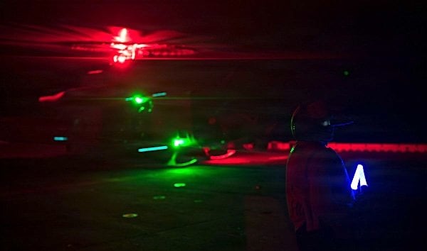 U.S. service members aboard amphibious assault ship USS Boxer support flight operations day and night from the Arabian Sea as CENTCOM enforces the naval blockade against Iran in July 2026. (U.S. Central Command photo)