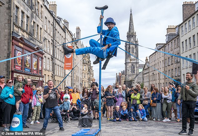 Guests staying in the capital this year have to pay the new visitor levy of 5 per cent on overnight stays for the first five consecutive stays. A street performer on Edinburgh's Royal Mile during the city's Festival Fringe