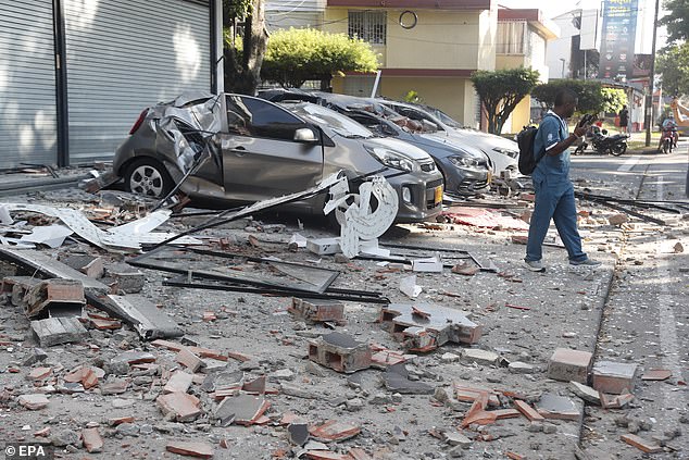 Vehicles damaged by a collapsed wall are seen following an earthquake in Cali, Colombia,  August 10 2026