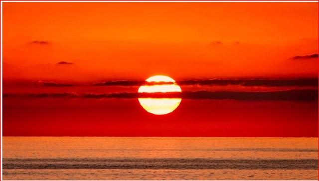 sunset over the ocean in orange