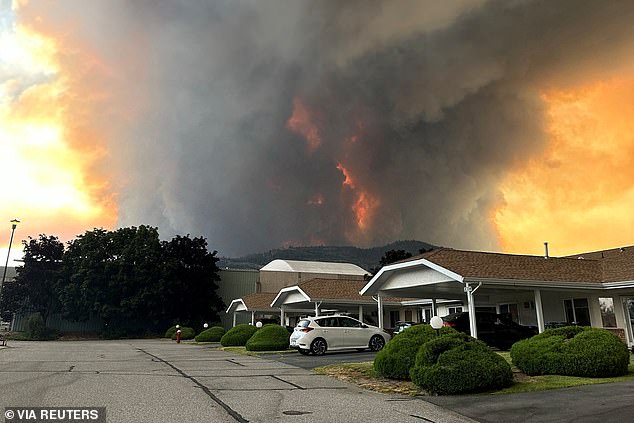 The blaze has ravaged at least 53 square miles across British Columbia since it erupted Friday. Smoke can be seen rising above a residential area in Summerland