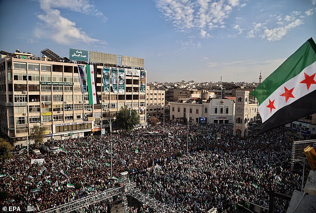 A general view shows hundreds of people gathered in Al-Assi Square during celebrations marking one year since the city's liberation, in Hama, Syria, December 5, 2025