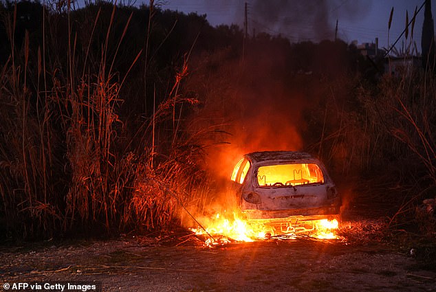 A car burns following clashes between Syria's new authorities and supporters of deposed president Bashar al-Assad near the town of Jableh in the coastal province of Latakia on March 10, 2025