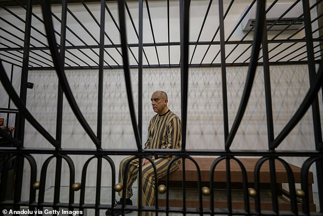 Atef Najib, wearing a striped prison uniform, sat seemingly emotionless last week in a cage in a courtroom in Central Palace of Justice, in Syria's capital, Damascus