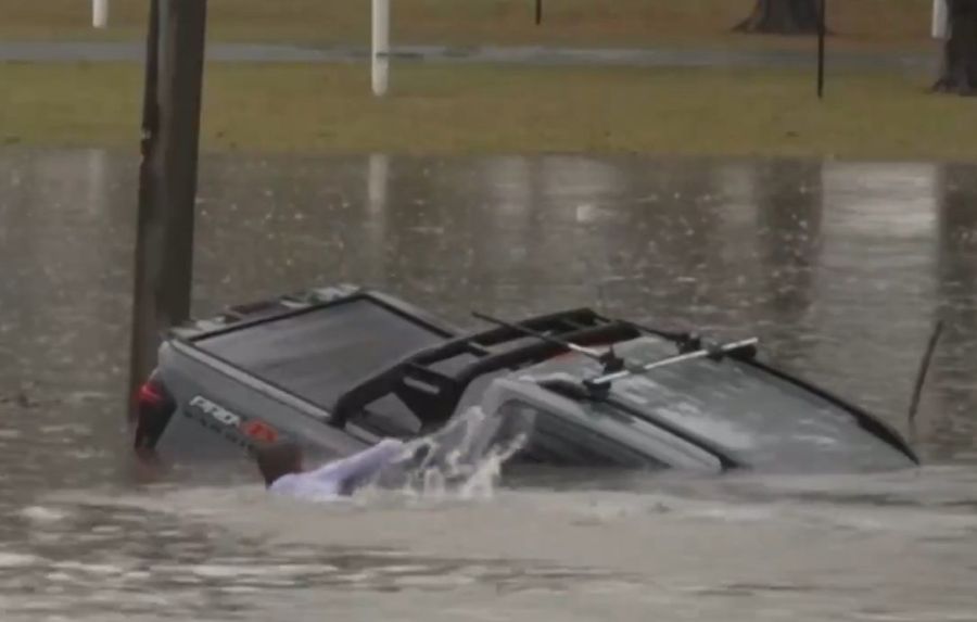 WATCH: ABC Reporter Dives Into Floodwaters To Save Man From Sinking SUV In Dramatic Clip
