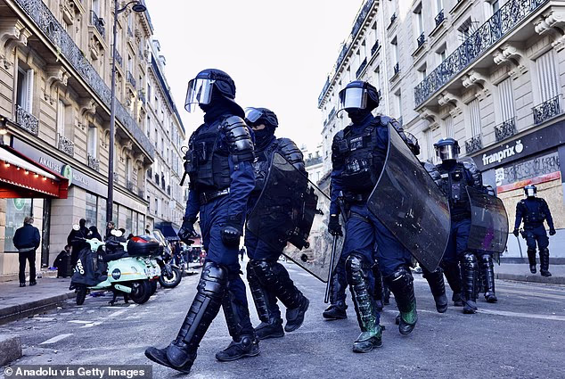 Police take security precautions as streets across Paris during nationwide protests.