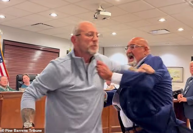 Wild moment New Jersey mayor charges at a resident in front of shocked locals during out-of-control public meeting