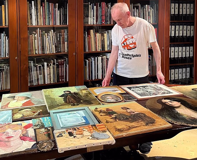 Peter Shaw examining a small selection of his collection of Scottish artworks