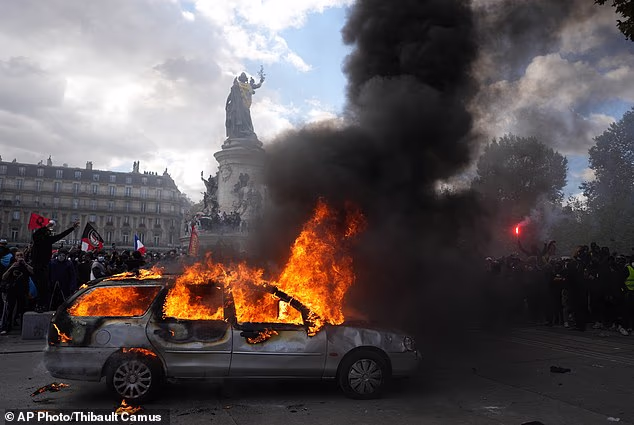 A car burns at Republique square during protests