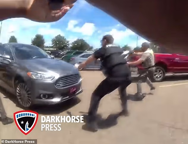 The footage showed officers surround the vehicle and yell 'Stop the car!' moments before it lurched forward, leading Foster to pull the trigger