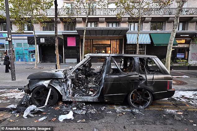 A burnt-out vehicle is seen following clashes during nationwide protests against the high cost of living and rising fuel prices in Paris, France