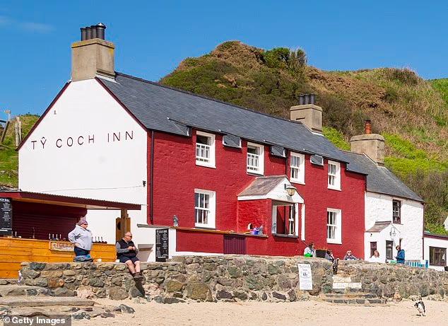 The Ty Coch Inn or 'Red House' is a well-known pub in the small coastal village of Porthdinllaen