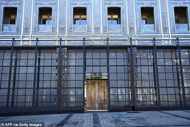 The boarded-up front window shop of luxury brand Dior on the Champs Elysees Avenue ahead of a protest in Paris
