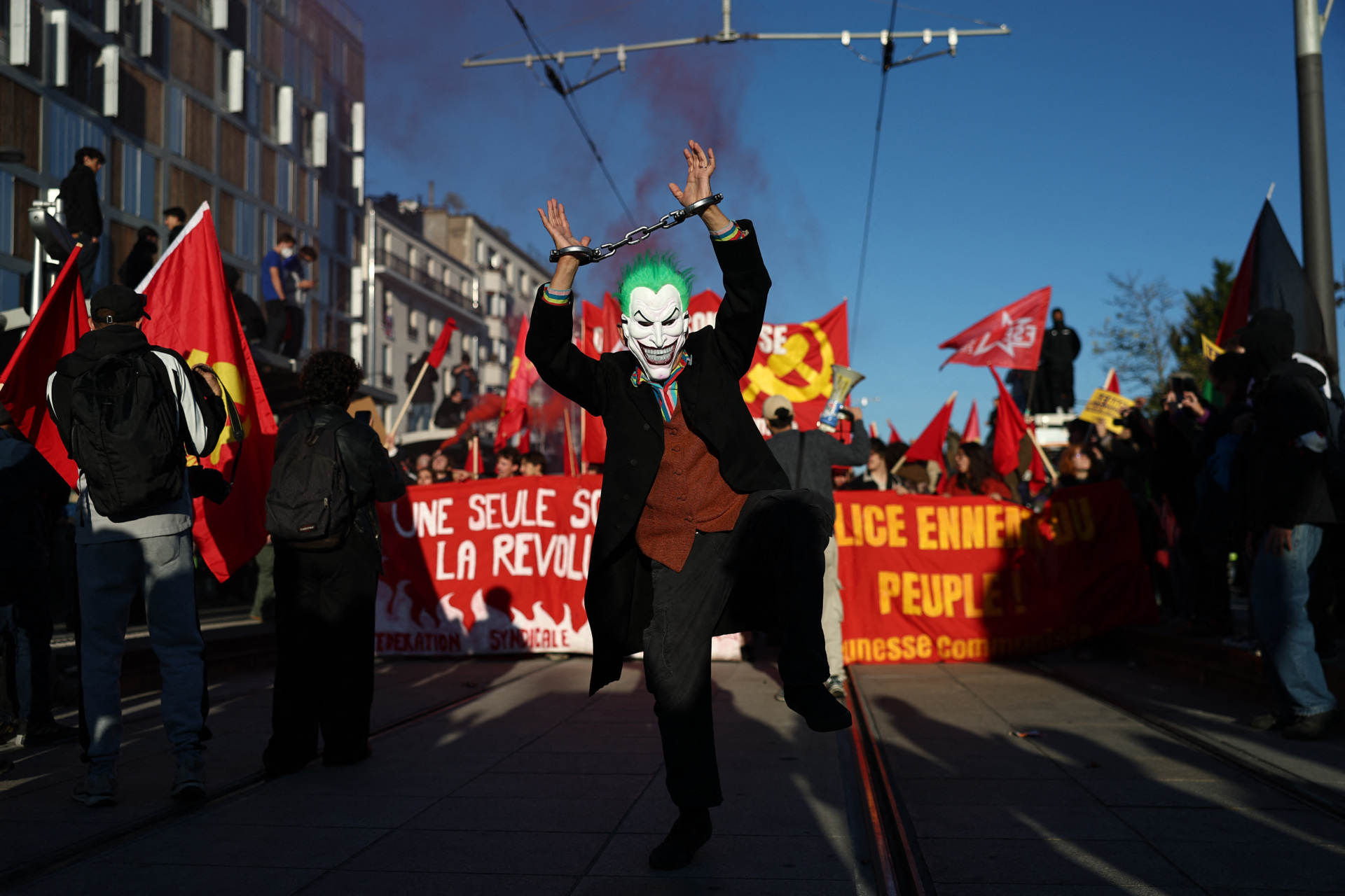A protester, dressed as the supervillain The Joker appearing in the American comic books published by DC Comics, takes part in a protest march during nationwide demonstrations over the rising cost of living and inequality organised by Yellow Vest movement, labour unions and high school and university students, in Paris on October 31, 2026. "Exceptional" security deployment with 70,000 police officers and gendarmes mobilized and an alarmist tone: for Act III of the protests against the high cost of living, right in the middle of Halloween festivities, the authorities fear a repeat of the October 17 nightmare. France has been rocked by widespread anger over the rising cost of living and inequality. (Photo by Sameer AL-DOUMY / AFP via Getty Images)