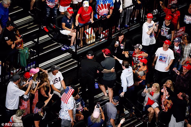 A protester is removed as US President Donald Trump delivers remarks during a midterm campaign rally at Ocean Center in Daytona Beach, Florida, US, October 30, 2026