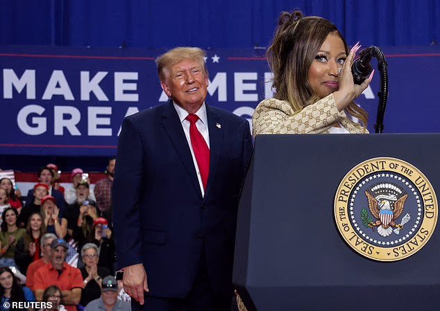 'By the way, I looked at one hell of a beautiful a** before: Nicki Minaj. That's hard to miss. Stand up. That's hard to miss,' Trump said at a Michigan rally with Minaj in attendance