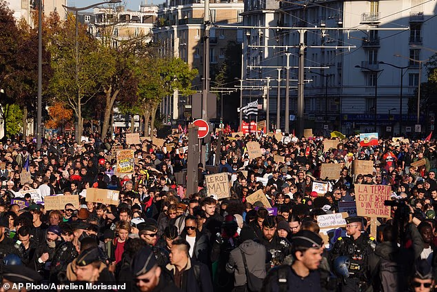 Protesters march during a demonstration against rising living costs in Paris on October 31