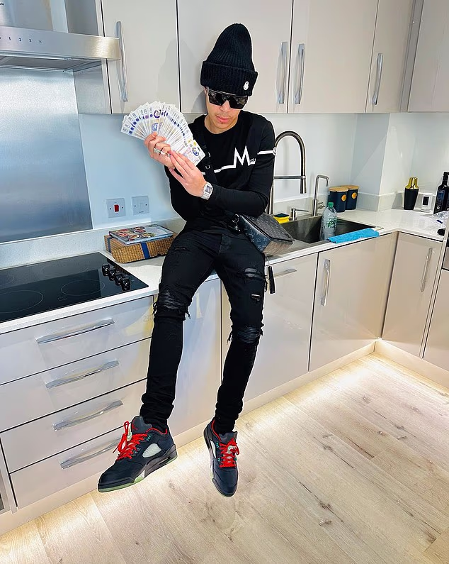 Charles showing off a large collection of £20 notes. He has spent months in jail after allegedly trying to steal £125,000 in cryptocurrency