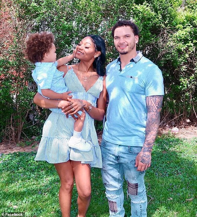 Police said that Baker had argued with his girlfriend Raneka Pate, seen here holding their late son Kentre, after coming out as gay. The family are seen here in a social media photo