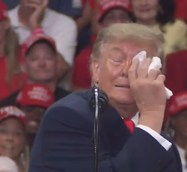 Trump is forced to pause rally as he struggles to keep his eye open... before slamming rumors about his health