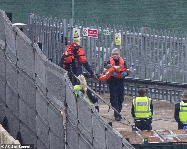 Migrant arrivals at Dover, including a child, on October 29 2026. Unaccompanied child arrivals by boat in Dover are taken to what is called the Kent Intake Unit on a hill by the port, where they are cared for by social workers
