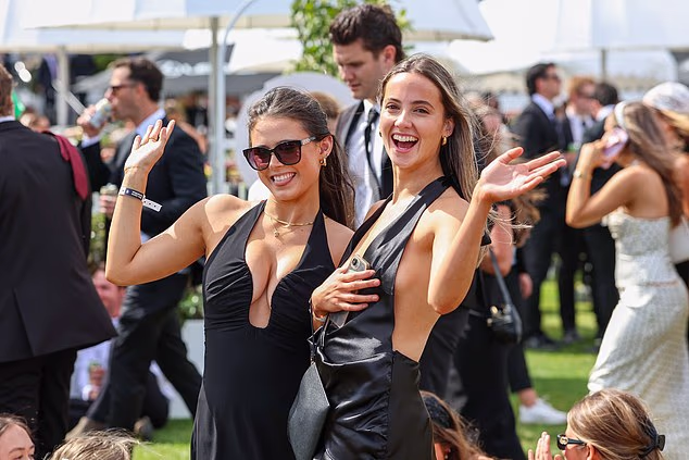 Racegoers dressed up and enjoying the afternoon