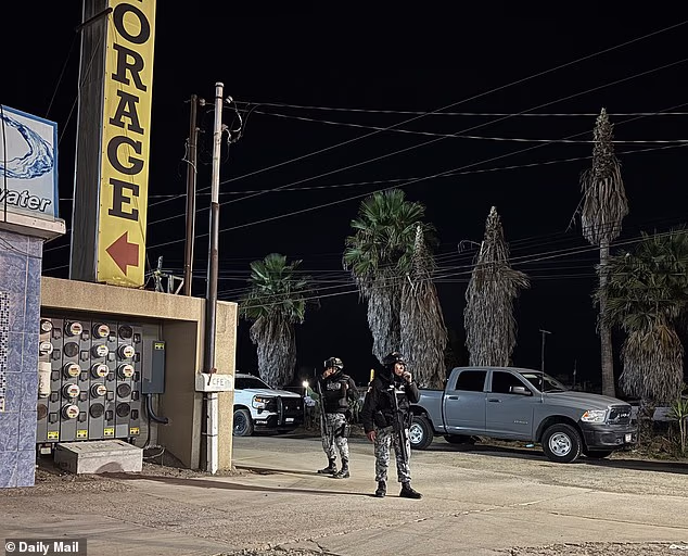 Armed cops are seen guarding the entrance to the facility during the raid of Thomas Markle's storage locker