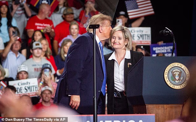 President Donald Trump shares a moment with U.S. Sen. Cindy Hyde-Smith on stage during a campaign rally at Crossroads Arena in Corinth