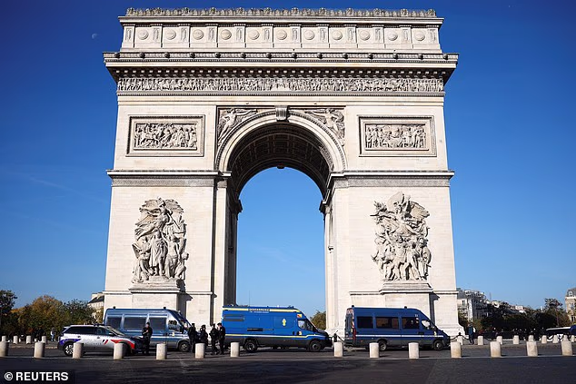 Police vans are pictured in front of the Arc de Triomphe on the day of a protest organised by labour unions as part of nationwide protests