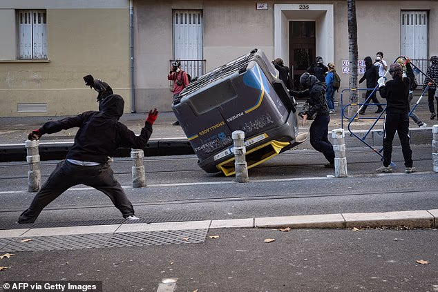 Protesters throw projectiles at the police during nationwide demonstrations over the rising cost of living and inequality organised by Yellow Vest movement