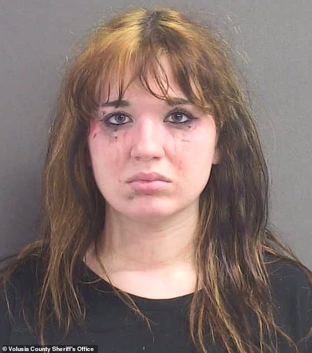 Hours later, Albro was arrested on charges of written threats to kill and unlawful use of a communications device. In her mugshot (pictured), mascara was seen streaking down her cheeks