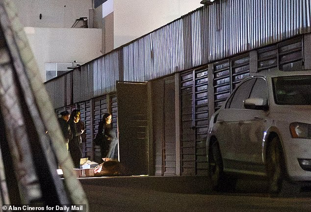 A wider shot of Saturday's raid shows members of the Guardia Nacional examining the contents of Thomas Markle's storage locker