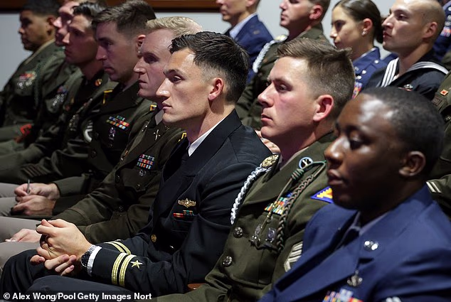 Members of the military listen as Secretary of Defense Pete Hegseth gives a State of the Force address at Marine Corps Base Quantico in September