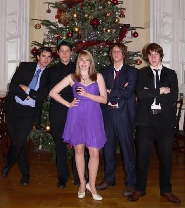A floppy-haired Clark, far right, stands with fellow UEA students, including Emmeline Saunders