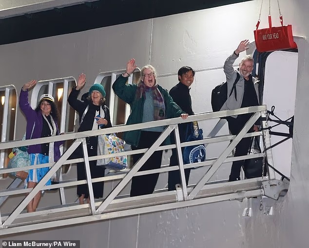 Passengers board the Villa Vie Odyssey cruise ship at Belfast Port's cruise ship terminal, after the luxury cruise ship became marooned in Belfast for four months in September 2024