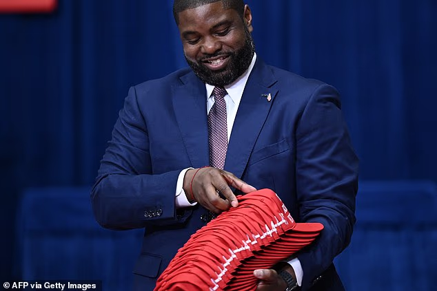 Gubernatorial candidate US Representative Byron Donalds, Republican from Florida, holds MAGA hats before throwing them to supporters as they wait for US President Donald Trump to speak at a midterm campaign rally at the Ocean Center in Daytona Beach, Florida on October 30, 2026