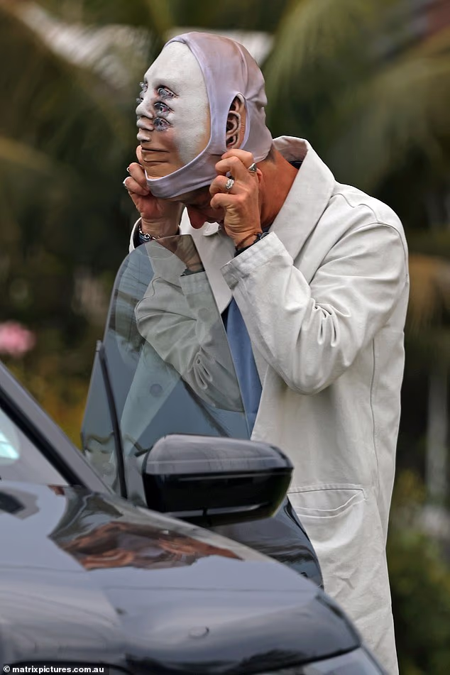 ...before revealing a rather trippy face mask