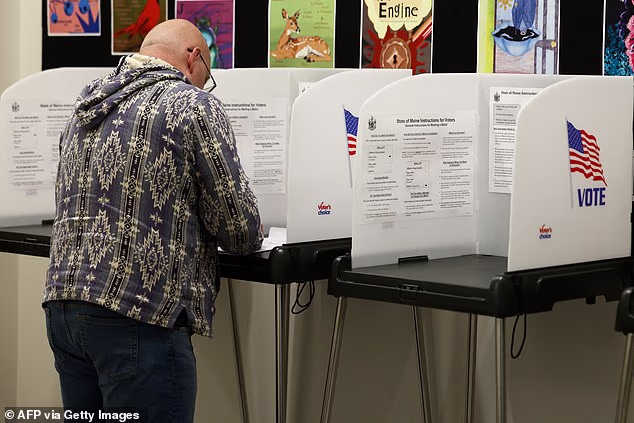 A man fills his ballot during early midterm voting in the town hall in Bangor, Maine, on October 16, 2026