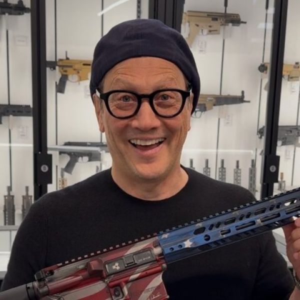 Comedian Rob Schneider Poses with AR-15: My 'Anti-Tesla ⁩Arson Protection Device'